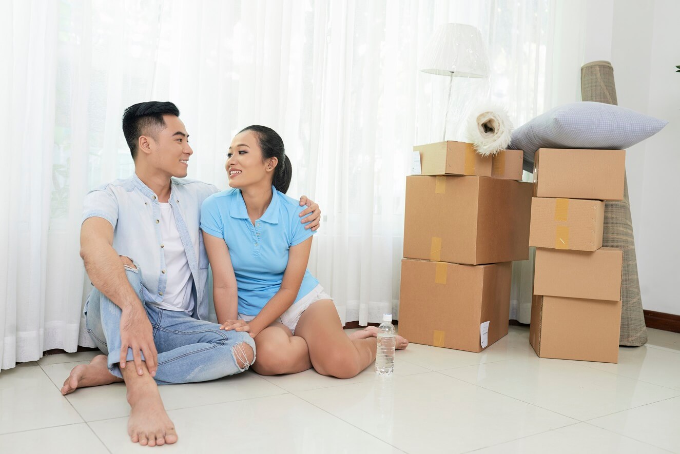 Professional piano movers handling an upright piano in Vancouver