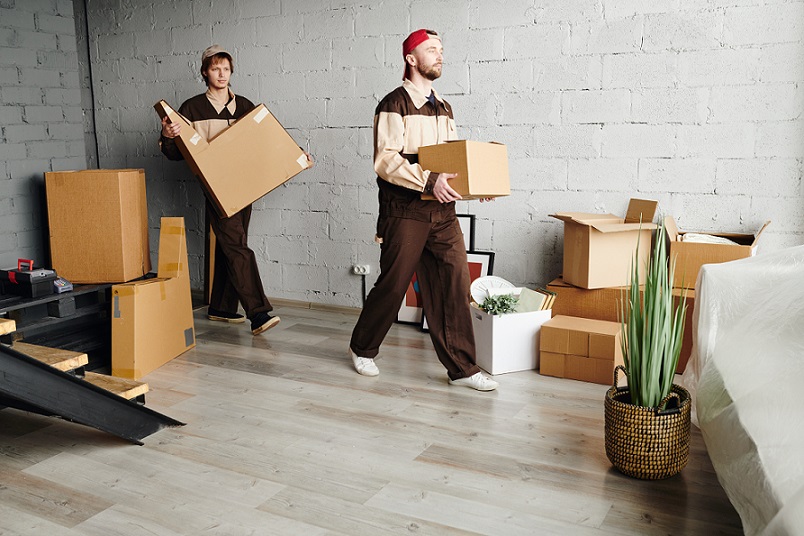 Professional Surrey movers loading a moving truck in front of a home