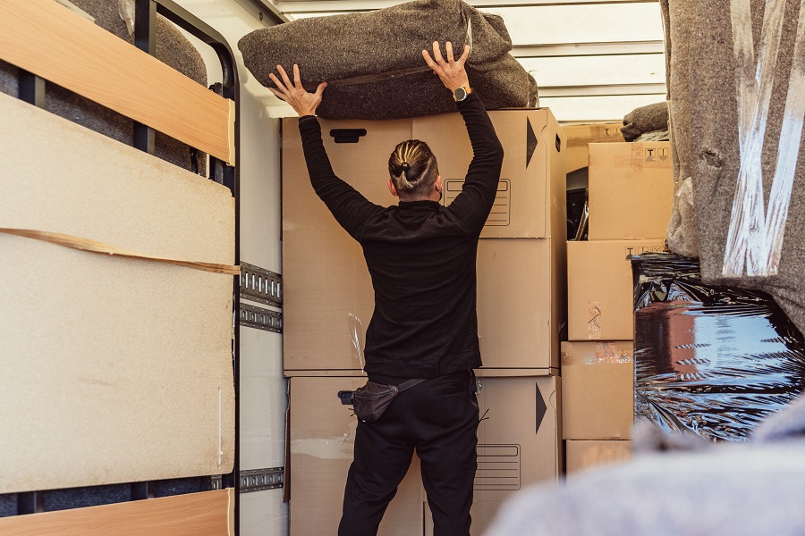 Surrey moving crew unloading boxes at a new home